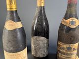 three bottles of wine are sitting next to each other on a table