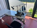 an image of a sewing machine on a table in front of a window