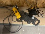 a picture of a corded drill and a hammer on the floor