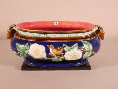 a blue and red bowl with a bird and flowers on it