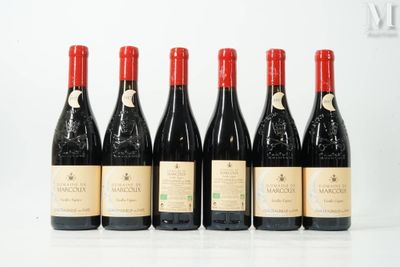 six bottles of wine are lined up on a white surface