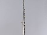 an old silver flute with a flute stand on a white background