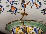a vase that has a bird on top of it