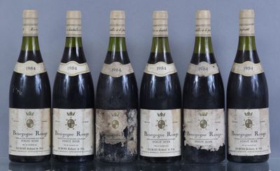 several bottles of wine are lined up on a table