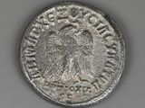a silver coin with an eagle on the front of it