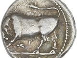 a close up of a silver coin with a bull on it