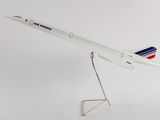 a white model of an airplane on a stand on a white background