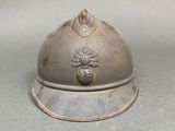 a silver helmet with a pine on it on a table