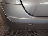 a close up of a car ' s bumper with a hole in it