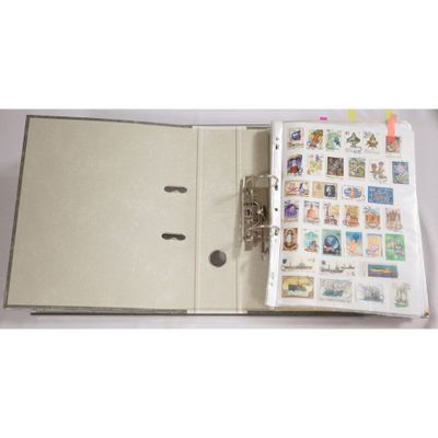 an open book with stamps on it on a table