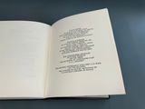 an open book with a poem on it sitting on top of a table