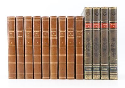 books are lined up in a row on a white surface