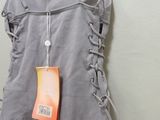 a dress hanging on a hanger on a wall