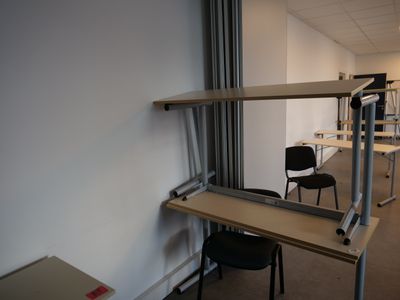 an image of a room with a desk and a chair