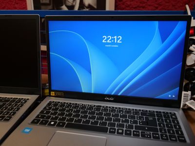 two laptops sitting side by side on a table
