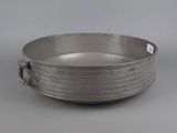a silver plate with a handle on a table