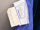 an image of a blue jacket with a label on it