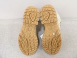 pair of shoes with soles on a gray surface with a white background