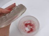 a person holding a donut with a bite taken out of it