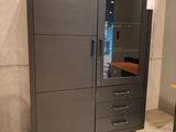a cabinet with drawers and a desk in the corner