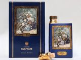 an image of a bottle of perfume next to a box of flowers
