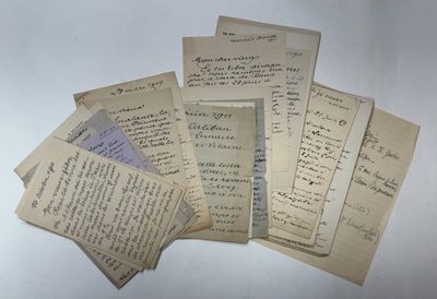 several old letters are stacked on top of each other on a table