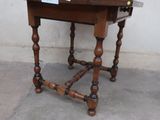 a wooden table with a glass of wine on top of it
