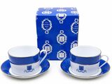 two cups and saucers with blue and white designs on them