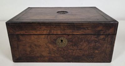 an old wooden box with a latch on the lid