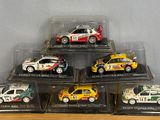 six different models of cars in a display case