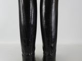 pair of black knee high boots on a white background