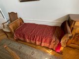 a bed with a red blanket on it in a room