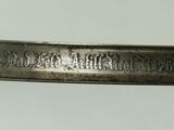 a close up of a knife on a white surface