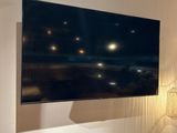un grand téléviseur à écran plat fixé au mur dans un salon