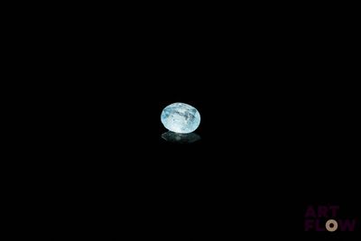 a blue moon in the dark sky with a reflection on the ground