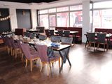 tables and chairs are set up in a restaurant with large windows