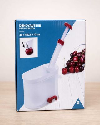 an image of a box with a red handle and cherries in it