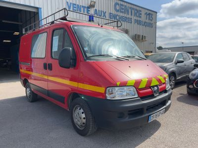 a red van that is parked in front of a building