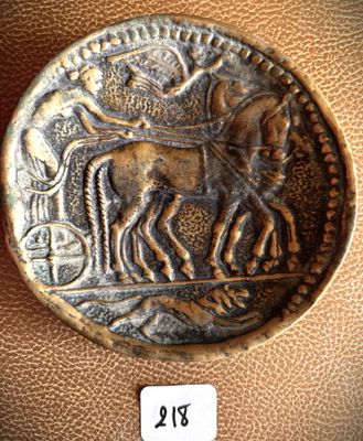 a close up of a coin with a horse and a man on it