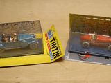 two toy cars that are in a box on a table