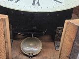 a clock that is sitting inside of a wooden box