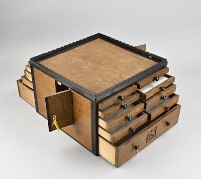 an image of a small wooden box with drawers on top of it