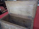 a wooden chest with carvings on the sides of it