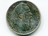 Gros plan sur une pièce de monnaie portant le visage d'un homme