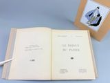 an open book sitting on top of a table next to a pen