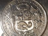 a close up of a silver coin with a coat of arms on it