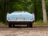 a blue car that is parked on the side of the road