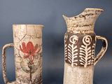 two vases sitting next to each other on a table