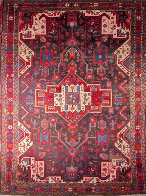a red and blue rug with an ornate design