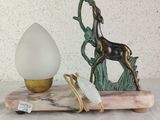 a statue of a horse and an egg sitting on a table